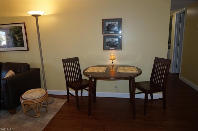 dining room with dark hardwood / wood-style flooring