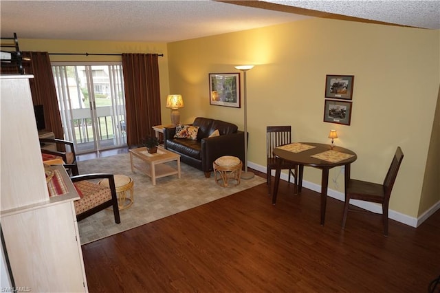 living room with hardwood / wood-style floors and a textured ceiling