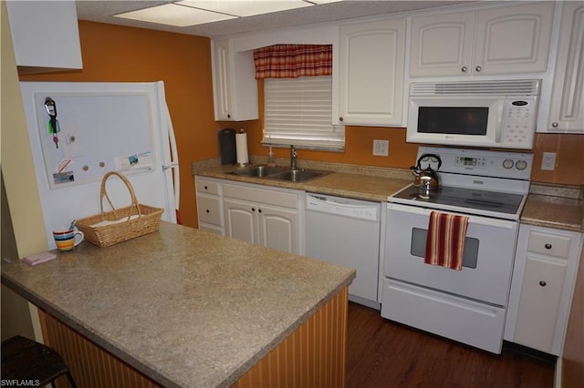 kitchen featuring dark hardwood / wood-style floors, white appliances, white cabinets, and sink