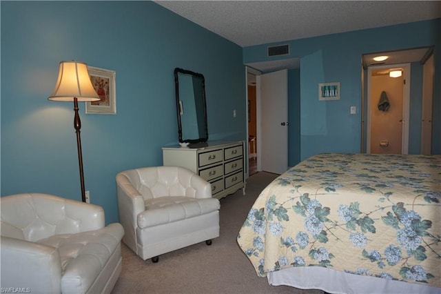 bedroom featuring a textured ceiling and carpet