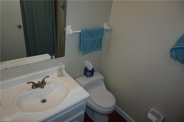 bathroom with toilet and large vanity