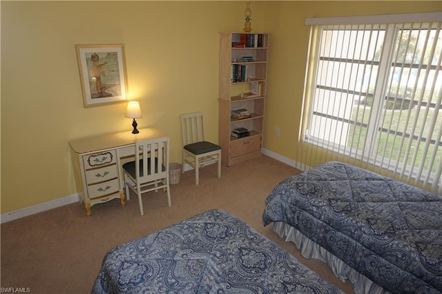 bedroom featuring light carpet and multiple windows