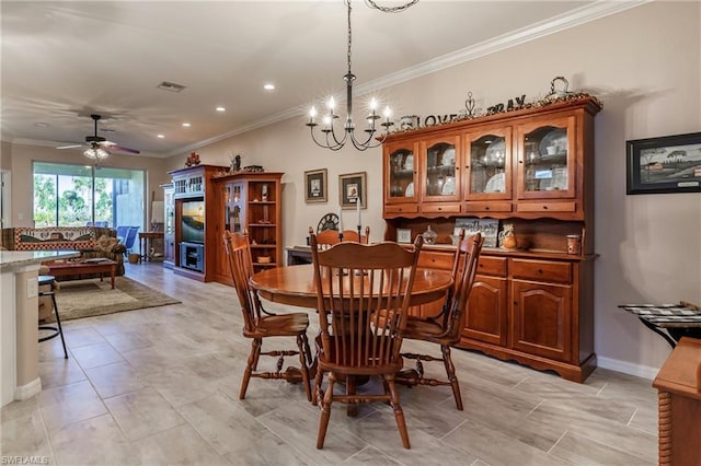 dining space with light tile floors, ceiling fan with notable chandelier, and ornamental molding