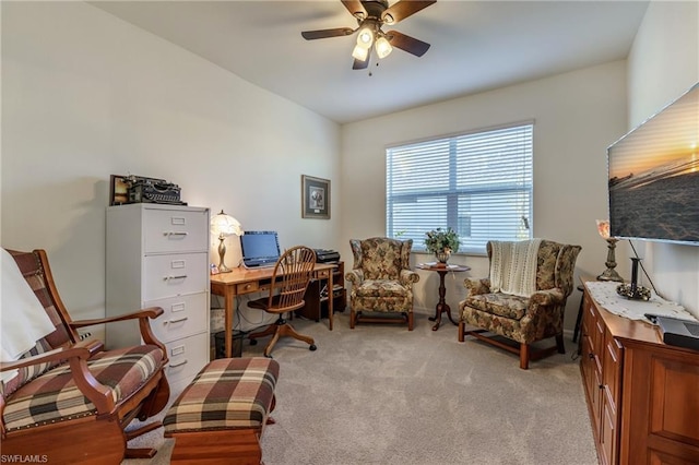 carpeted home office featuring ceiling fan