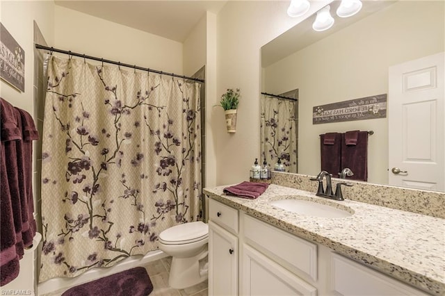 bathroom featuring vanity, tile floors, and toilet