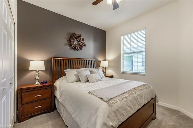 carpeted bedroom with a closet and ceiling fan