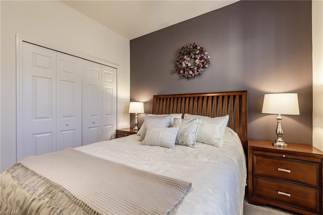 bedroom with a closet and light colored carpet