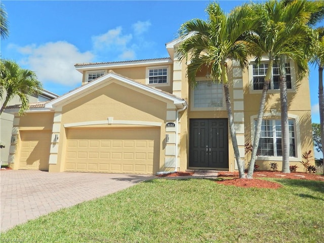 mediterranean / spanish home with a front lawn and a garage