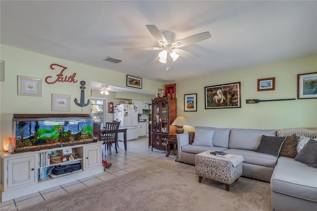 tiled living room featuring ceiling fan