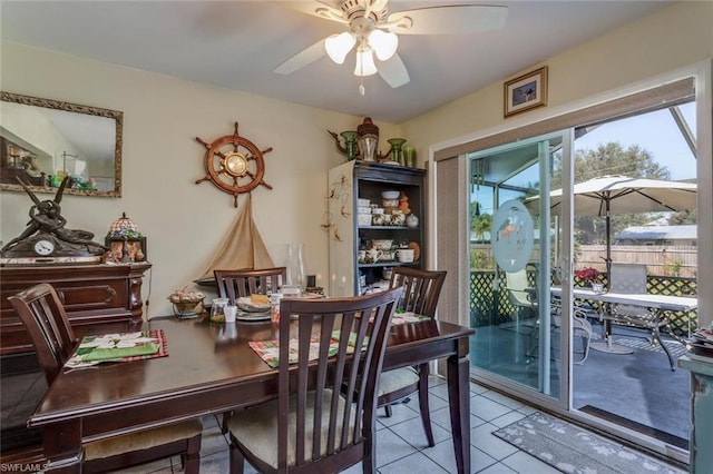 dining space with light tile floors and ceiling fan