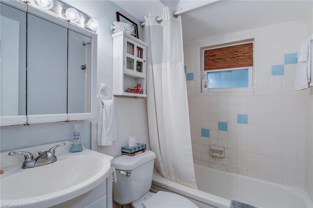 full bathroom with shower / tub combo, vanity, and toilet