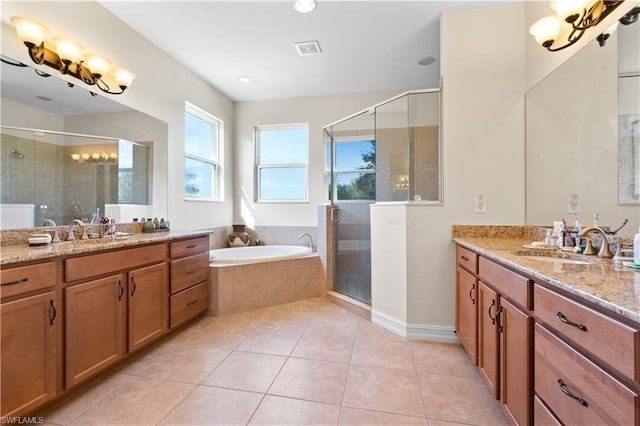 bathroom featuring tile floors, vanity, and independent shower and bath