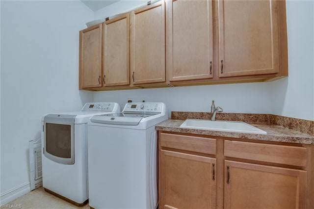 laundry room with washer and clothes dryer, cabinets, and sink