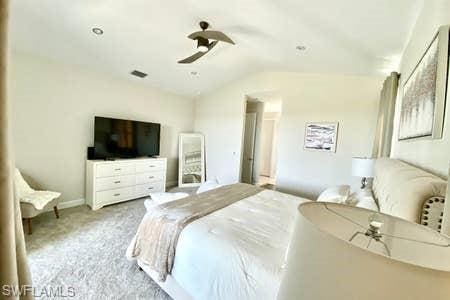 bedroom featuring lofted ceiling, light colored carpet, and ceiling fan