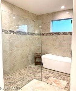 bathroom with tile walls and tile flooring