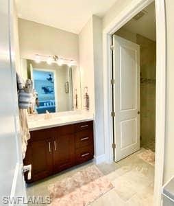 bathroom featuring tile floors and vanity with extensive cabinet space