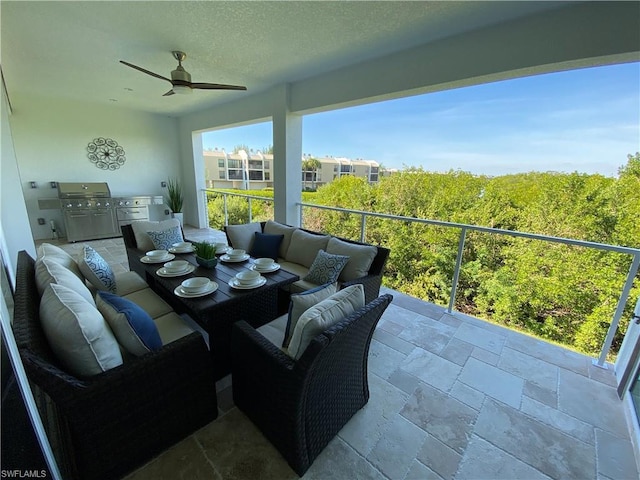 balcony featuring exterior kitchen, outdoor lounge area, ceiling fan, and a grill