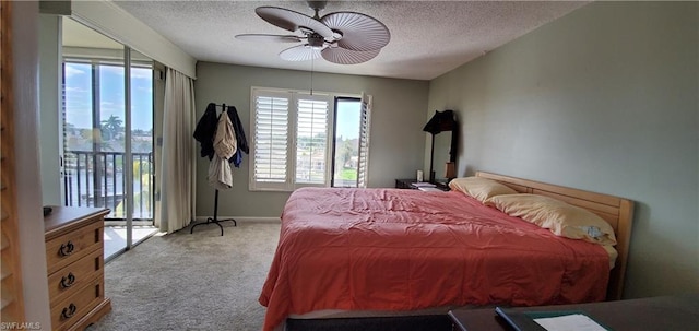 carpeted bedroom featuring access to outside, a textured ceiling, and ceiling fan