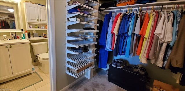 spacious closet featuring light tile floors