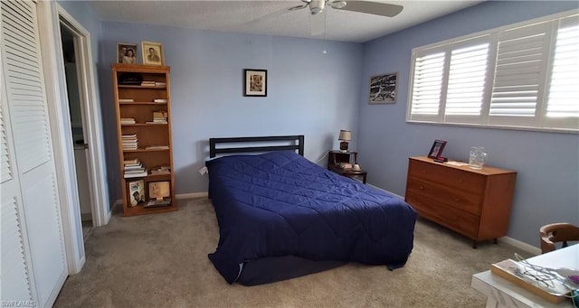 carpeted bedroom with a closet and ceiling fan