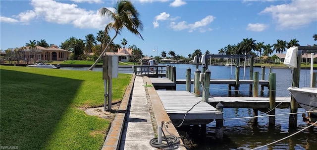 dock area featuring a water view and a lawn