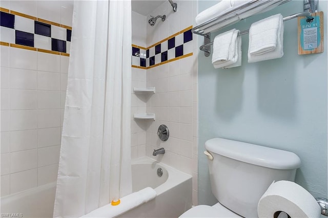 bathroom featuring shower / bath combination with curtain and toilet