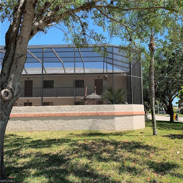 exterior space featuring a yard and a lanai