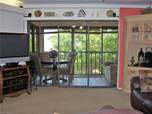 carpeted dining space with crown molding and a wealth of natural light