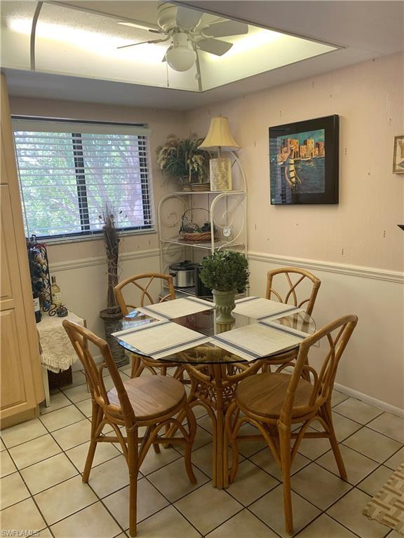 dining space with light tile floors and ceiling fan