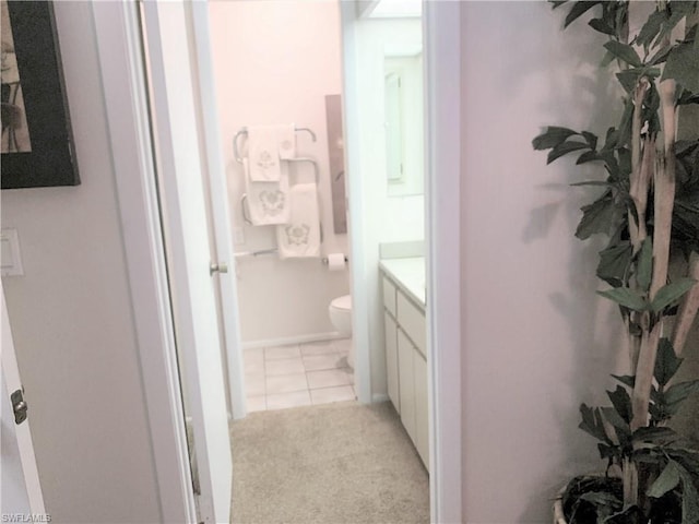 bathroom featuring tile floors, toilet, and vanity