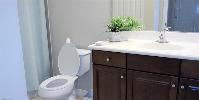 bathroom featuring toilet and vanity