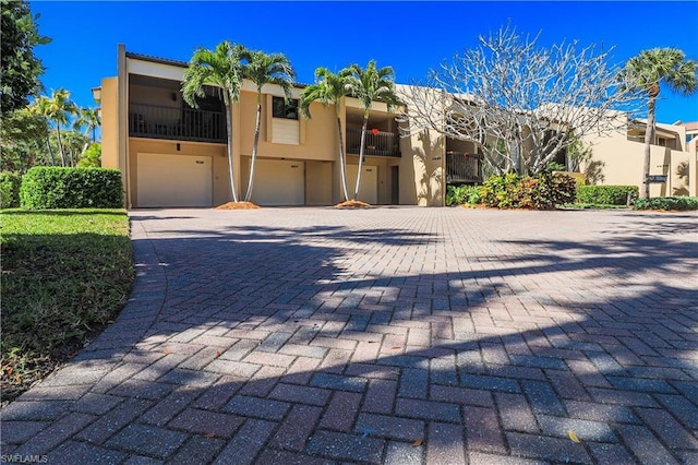 view of front of home with a balcony and a garage