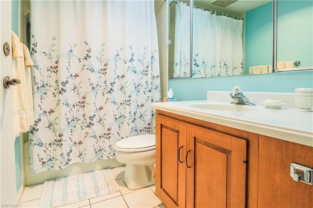 bathroom featuring vanity, tile floors, and toilet