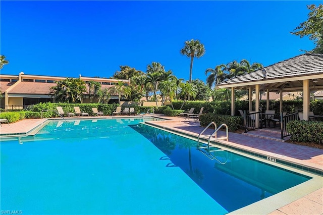 view of swimming pool featuring a gazebo and a patio