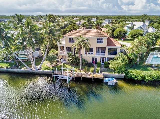 dock area with a balcony and a water view