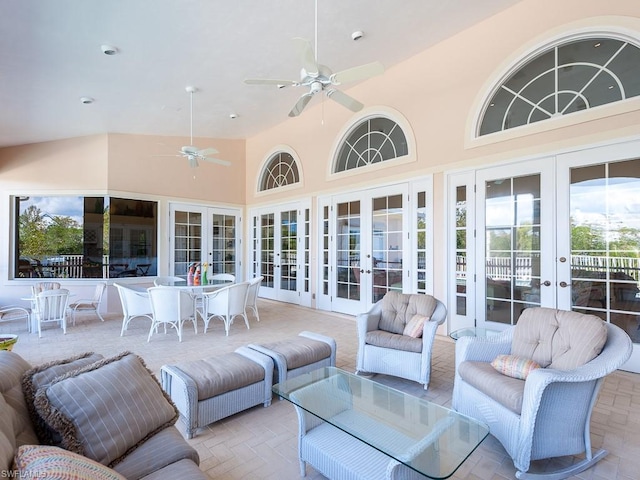 sunroom / solarium featuring french doors, ceiling fan, and lofted ceiling