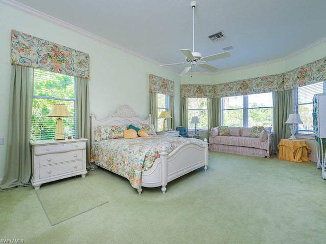 bedroom with ornamental molding, light colored carpet, and ceiling fan