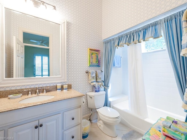 full bathroom with toilet, oversized vanity, ceiling fan, tile flooring, and shower / tub combo with curtain