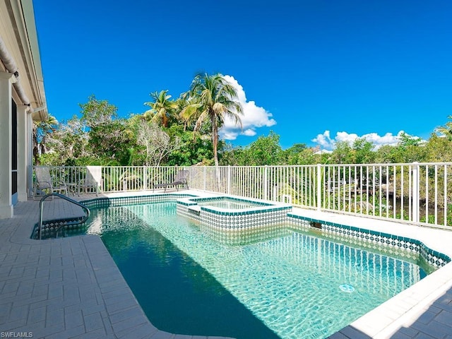 view of swimming pool with a patio area and an in ground hot tub