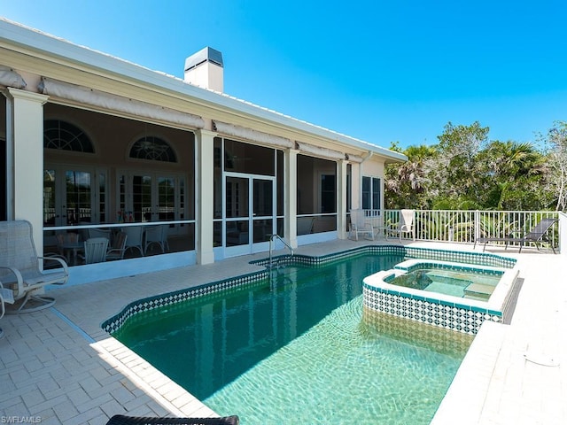 view of swimming pool with an in ground hot tub and a patio