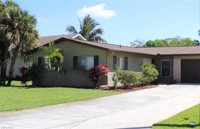 view of side of home with a yard and a garage