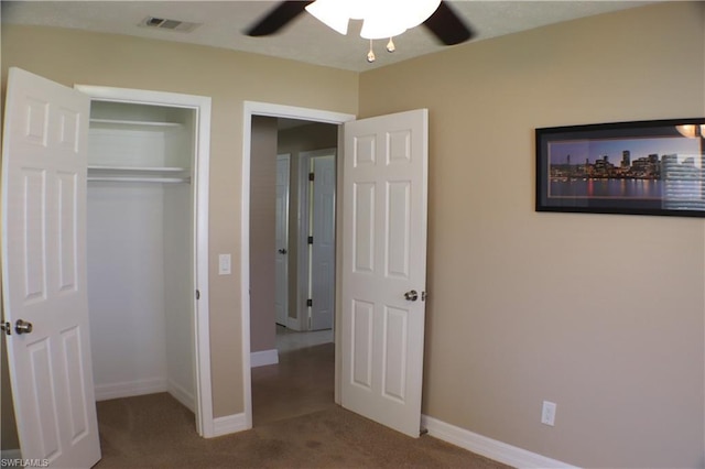 unfurnished bedroom with carpet floors, a closet, and ceiling fan