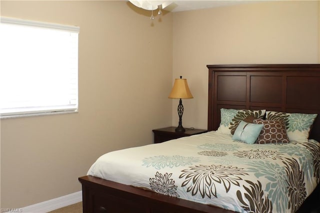 carpeted bedroom with multiple windows