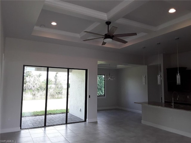 tiled spare room featuring ceiling fan with notable chandelier, sink, a wealth of natural light, and coffered ceiling