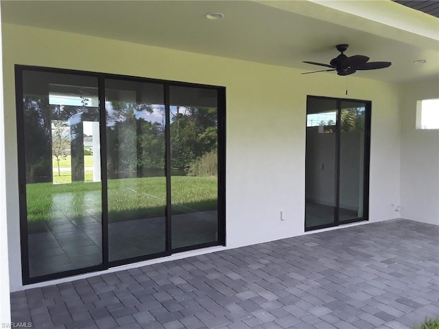 exterior space with ceiling fan