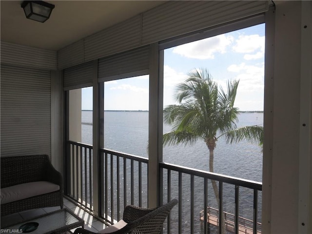 sunroom / solarium with a water view