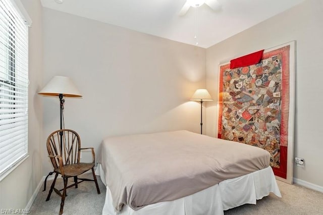 bedroom with light carpet and ceiling fan