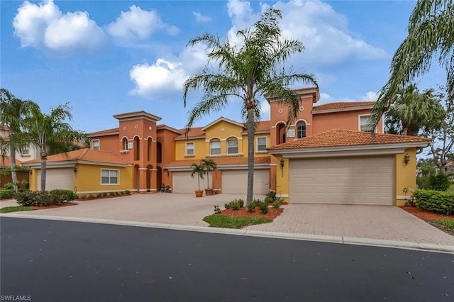 mediterranean / spanish-style home with a garage