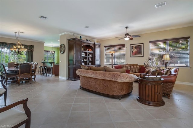 living room with crown molding, light tile floors, and ceiling fan with notable chandelier