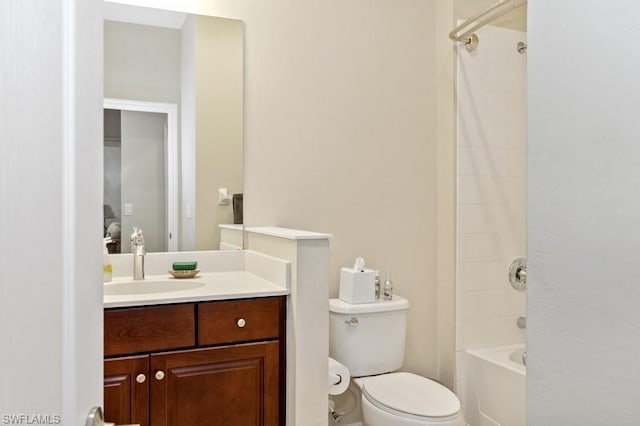 full bathroom with tiled shower / bath, toilet, and vanity